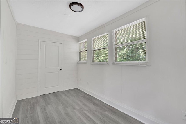 unfurnished room with wood finished floors and baseboards