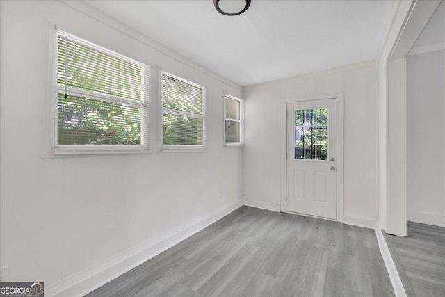 interior space featuring wood finished floors and baseboards
