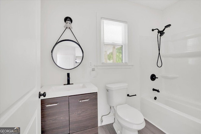 bathroom featuring toilet, shower / washtub combination, and vanity