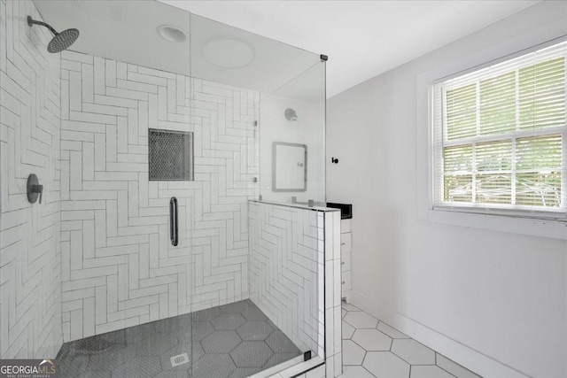 full bathroom featuring tile patterned flooring, a stall shower, and baseboards