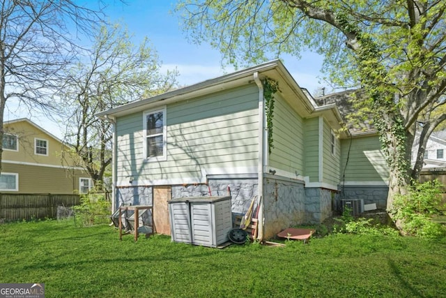 back of property featuring a yard and fence