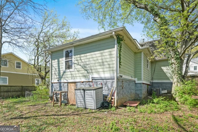 back of house with fence