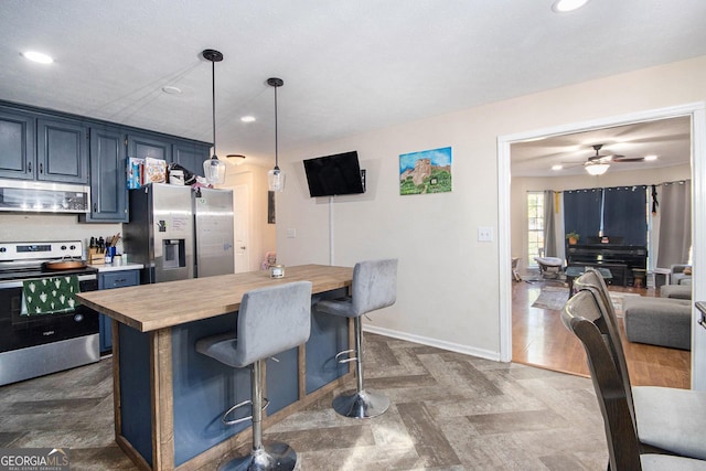 286 Opal St, Luthersville, GA 30251 - kitchen with wooden counters, a kitchen bar, recessed lighting, blue cabinets, and stainless steel appliances