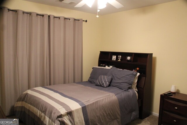 bedroom featuring visible vents, ceiling fan, and carpet