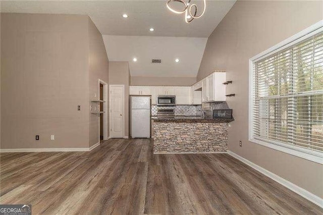 328 Allatoona Shores Dr, Canton, GA 30114 - kitchen featuring freestanding refrigerator, high vaulted ceiling, visible vents, white cabinets, and stainless steel microwave