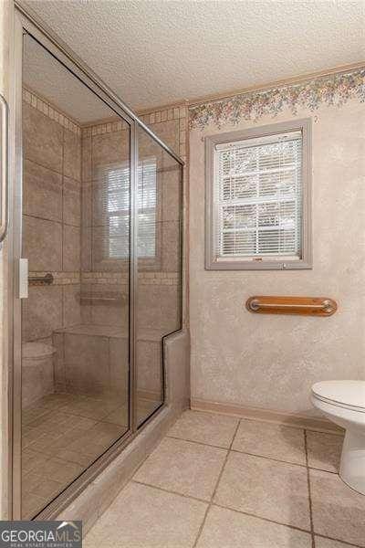328 Allatoona Shores Dr, Canton, GA 30114 - full bathroom with a textured ceiling, baseboards, tile patterned flooring, and a stall shower