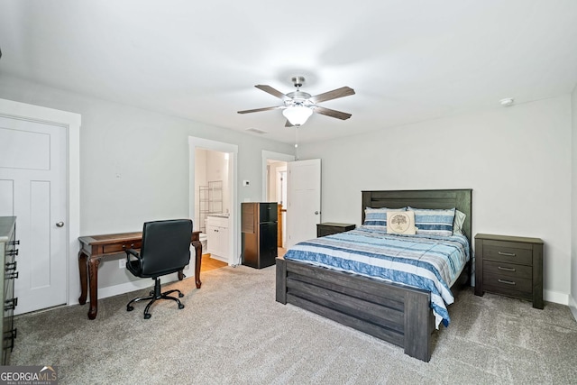 carpeted bedroom featuring visible vents, baseboards, ceiling fan, and ensuite bathroom