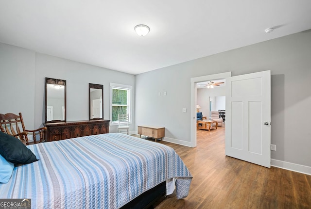 bedroom with baseboards and wood finished floors