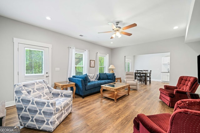 living room with visible vents, recessed lighting, a ceiling fan, and wood finished floors
