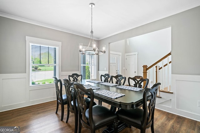 dining area featuring ornamental molding, a wainscoted wall, stairs, a notable chandelier, and dark wood-style floors
