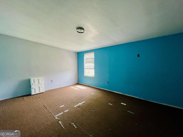 1546 Bob Mann Rd, Maysville, GA 30558 - carpeted empty room with baseboards and a textured ceiling