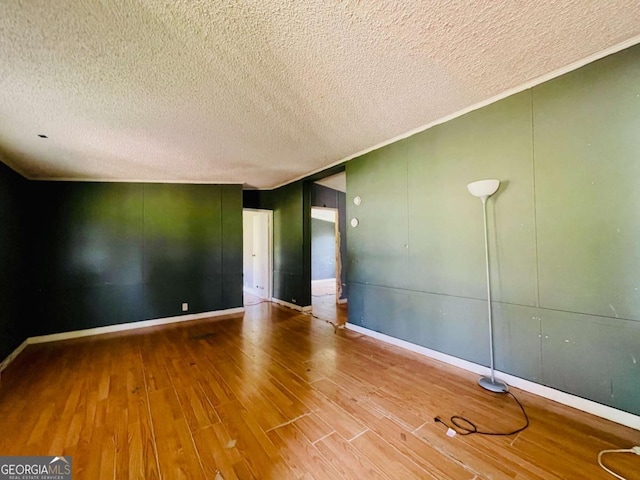 1546 Bob Mann Rd, Maysville, GA 30558 - empty room with a textured ceiling, wood finished floors, and baseboards