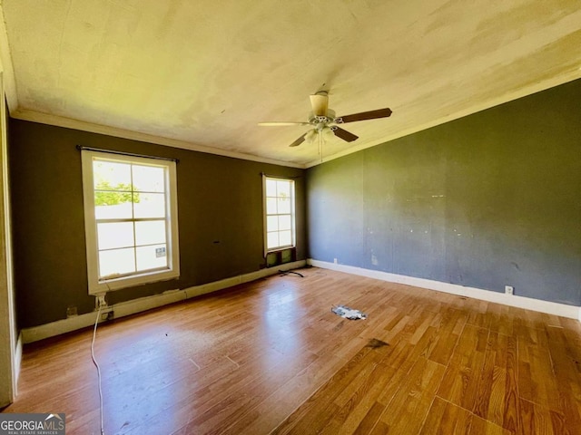 1546 Bob Mann Rd, Maysville, GA 30558 - spare room featuring crown molding, baseboards, a ceiling fan, and wood finished floors