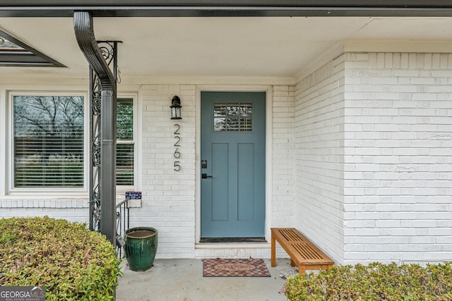 view of exterior entry with brick siding
