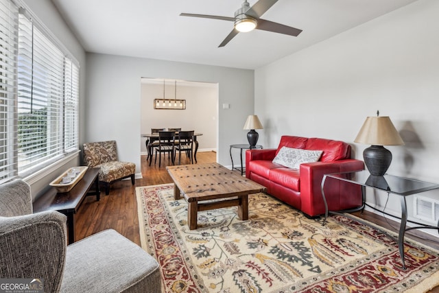 living area with wood finished floors and ceiling fan