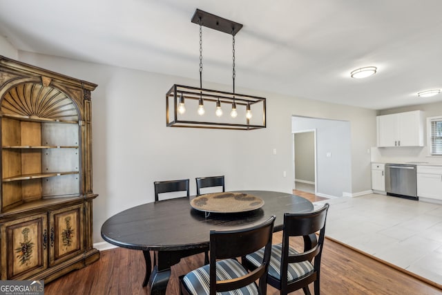 dining area with light wood finished floors and baseboards