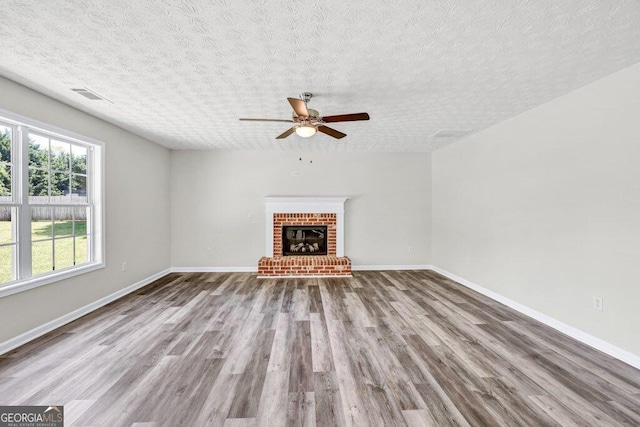 kitchen featuring plenty of natural light, a fireplace, dishwasher, and a sink