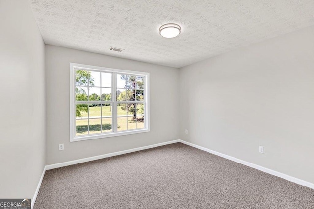 hallway featuring dark wood-type flooring, a textured ceiling, and baseboards