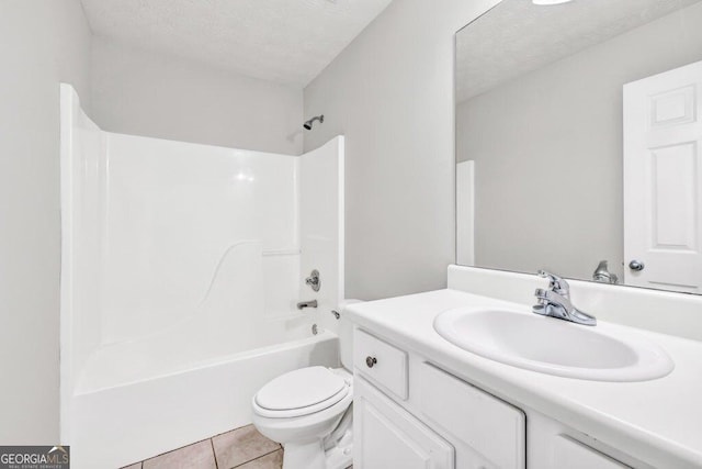 carpeted spare room featuring a textured ceiling and baseboards