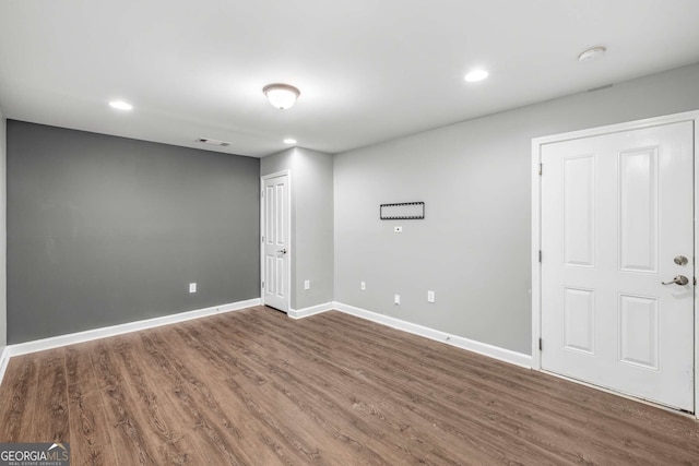 unfurnished room featuring visible vents, baseboards, recessed lighting, and wood finished floors