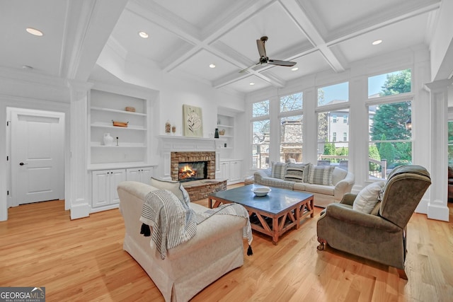 866 Coopers Ridge Path SW, Grayson, GA 30017 - living room featuring ceiling fan, built in features, coffered ceiling, a fireplace, and light wood-style floors