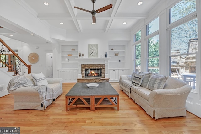 866 Coopers Ridge Path SW, Grayson, GA 30017 - living room with a ceiling fan, built in shelves, a fireplace, light wood finished floors, and coffered ceiling