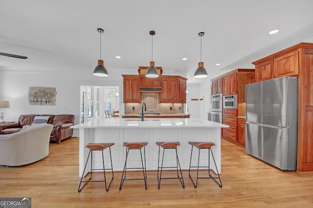 866 Coopers Ridge Path SW, Grayson, GA 30017 - kitchen featuring stainless steel appliances, a sink, open floor plan, light countertops, and a breakfast bar