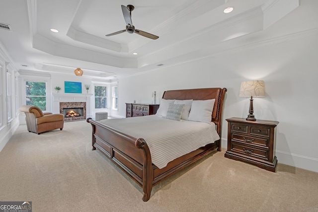 866 Coopers Ridge Path SW, Grayson, GA 30017 - bedroom featuring a raised ceiling, carpet flooring, crown molding, a glass covered fireplace, and recessed lighting