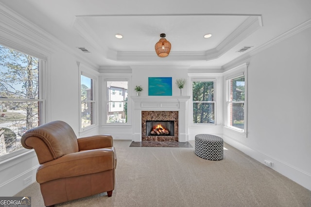 866 Coopers Ridge Path SW, Grayson, GA 30017 - carpeted living area featuring healthy amount of natural light, crown molding, a high end fireplace, and a raised ceiling
