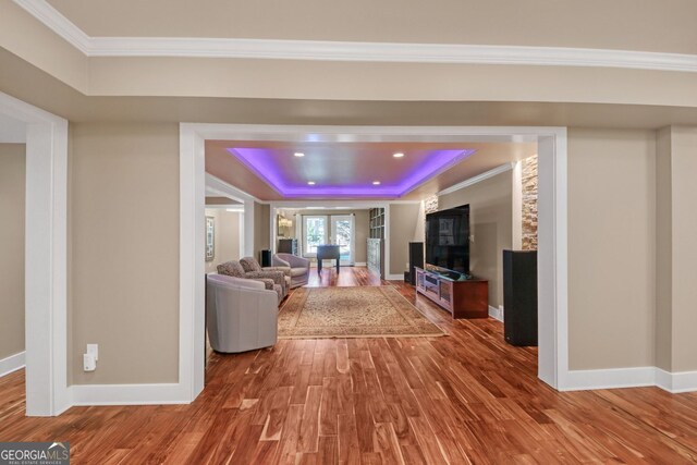 866 Coopers Ridge Path SW, Grayson, GA 30017 - living room featuring a tray ceiling, wood finished floors, baseboards, ornamental molding, and a fireplace