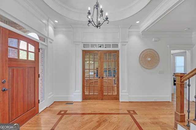 866 Coopers Ridge Path SW, Grayson, GA 30017 - entryway featuring french doors, crown molding, light wood-type flooring, a chandelier, and baseboards