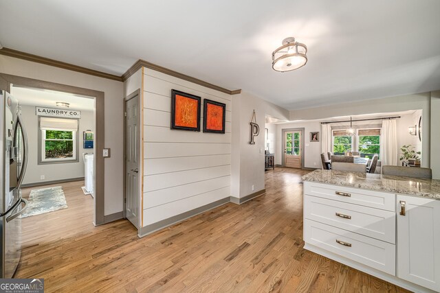 16080 Freemanville Rd, Alpharetta, GA 30004 - kitchen with appliances with stainless steel finishes, under cabinet range hood, a sink, white cabinetry, and light stone counters