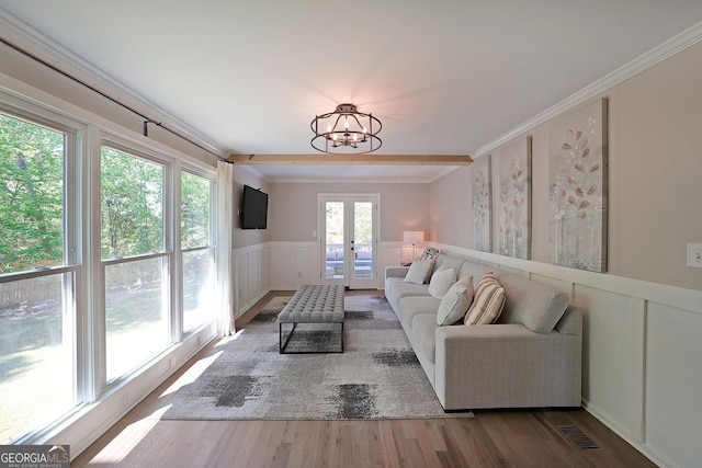 16080 Freemanville Rd, Alpharetta, GA 30004 - living room featuring a decorative wall, french doors, wood finished floors, wainscoting, and a chandelier