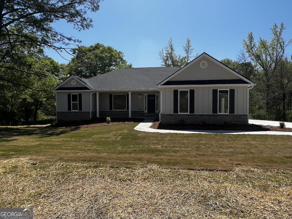 328 Advent Dr, Winder, GA 30680 - single story home featuring a shingled roof, brick siding, board and batten siding, and a front lawn