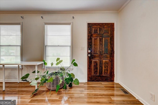 241 Burke Cir, Mcdonough, GA 30253 - entryway featuring light wood-style floors, a wealth of natural light, visible vents, and ornamental molding