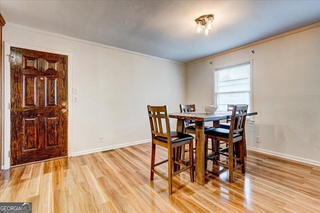 241 Burke Cir, Mcdonough, GA 30253 - dining room featuring baseboards, light wood-type flooring, and crown molding
