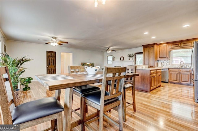 241 Burke Cir, Mcdonough, GA 30253 - dining area with light wood-style flooring, crown molding, a ceiling fan, and recessed lighting