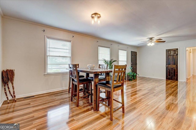 241 Burke Cir, Mcdonough, GA 30253 - dining area with visible vents, baseboards, ornamental molding, a ceiling fan, and light wood-style floors