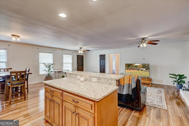 241 Burke Cir, Mcdonough, GA 30253 - kitchen featuring a healthy amount of sunlight, a center island, and ceiling fan