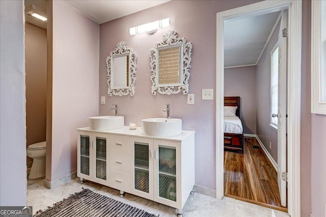241 Burke Cir, Mcdonough, GA 30253 - ensuite bathroom with a sink, baseboards, and double vanity