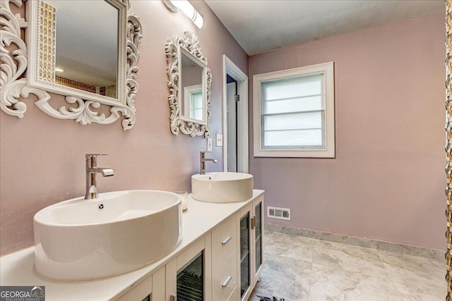 241 Burke Cir, Mcdonough, GA 30253 - full bathroom with double vanity, visible vents, baseboards, and a sink
