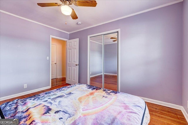 241 Burke Cir, Mcdonough, GA 30253 - bedroom with a closet, baseboards, a ceiling fan, and wood finished floors