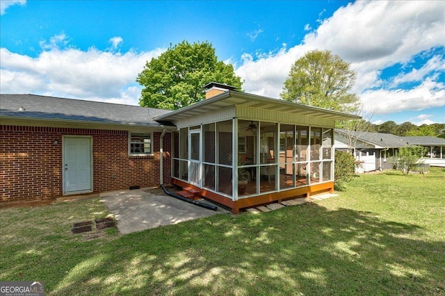 241 Burke Cir, Mcdonough, GA 30253 - rear view of property with a sunroom, a chimney, a lawn, and brick siding