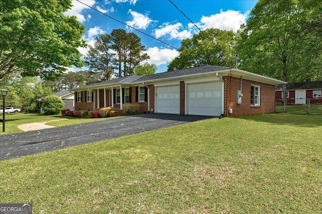 241 Burke Cir, Mcdonough, GA 30253 - ranch-style home with a front lawn, aphalt driveway, brick siding, a garage, and fence
