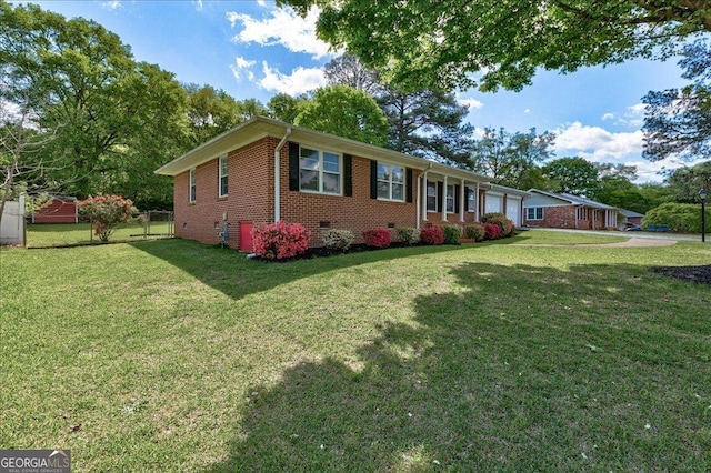 241 Burke Cir, Mcdonough, GA 30253 - exterior space with crawl space, a front yard, fence, brick siding, and an attached garage