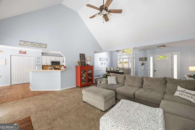 840 Whitby Dr, Douglasville, GA 30134 - living area featuring high vaulted ceiling, baseboards, a ceiling fan, and carpet floors
