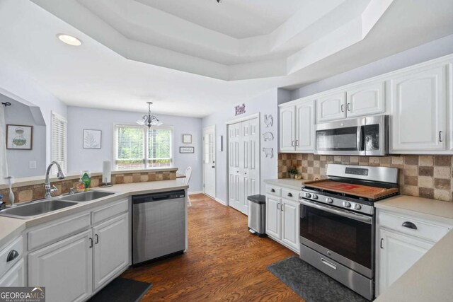 840 Whitby Dr, Douglasville, GA 30134 - kitchen featuring tasteful backsplash, white cabinets, a sink, stainless steel appliances, and a notable chandelier