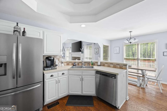 840 Whitby Dr, Douglasville, GA 30134 - kitchen featuring dark wood-style flooring, a peninsula, white cabinetry, stainless steel appliances, and a sink