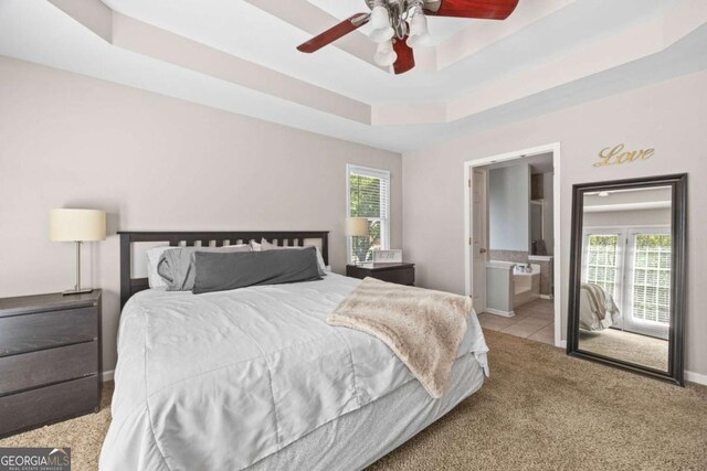 840 Whitby Dr, Douglasville, GA 30134 - tiled bedroom featuring a tray ceiling, carpet, multiple windows, and baseboards