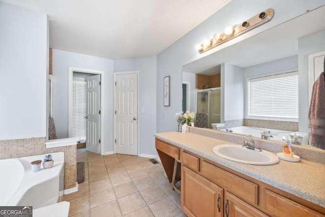 840 Whitby Dr, Douglasville, GA 30134 - bathroom featuring baseboards, a shower stall, vanity, tile patterned flooring, and a garden tub
